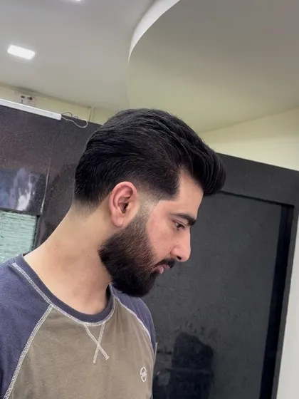 A side profile of a classic side part with a taper fade.