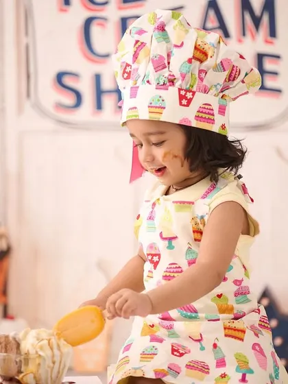 This little chef is hard at work in our studio's ice cream shop. We love capturing these playful, interactive moments during our themed sessions.