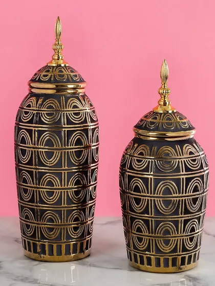 Part of my 'Black Beauties' collection, these ceramic vases feature an intricate art deco-inspired pattern in gold on a black base. They are perfect for adding a touch of glamour and sophistication.