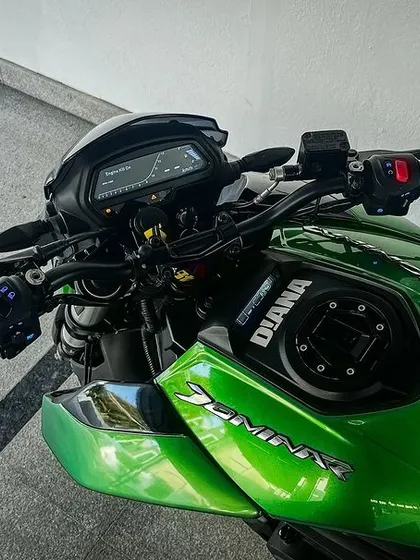 A top-down view of the cockpit of "Diana," our green Dominar, showcasing its clean lines and rider-focused controls.