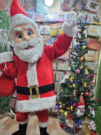 Another look at our cheerful Santa Claus mascot. The performer is ready to interact with children and adults, listen to Christmas wishes, and create a truly festive atmosphere.