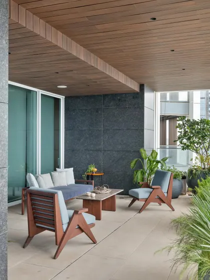 The breezy open deck of the Worli apartment serves as an extension of the living spaces. It provides a private outdoor area to unwind and take in the view, creating a sanctuary within the dense urban environment.