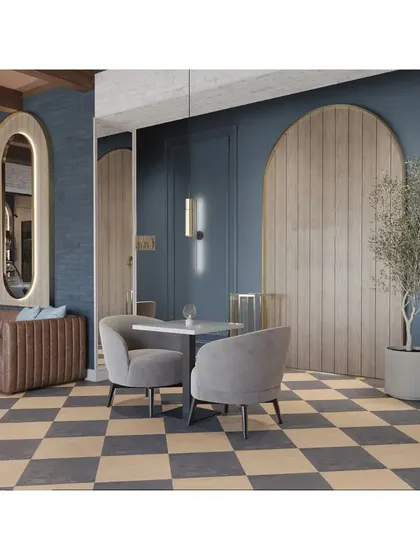 A seating nook with a comfortable brown leather banquette against a deep blue wall. The large, gold-framed mirror and wood-paneled feature add warmth and sophistication.