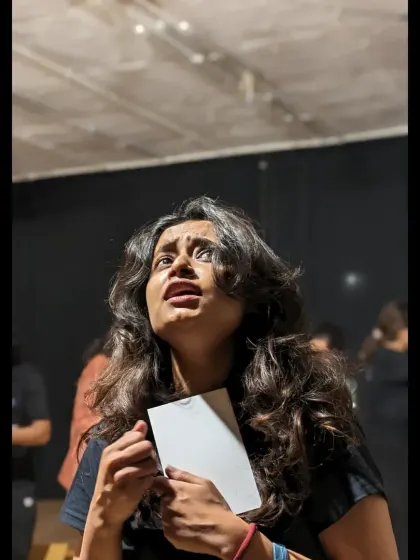 An actor's expression captures a moment of vulnerability and hope during a rehearsal.