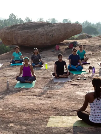 An outdoor yoga session in the middle of the Hampi boulders. We start our days by connecting with our bodies and the nature around us.