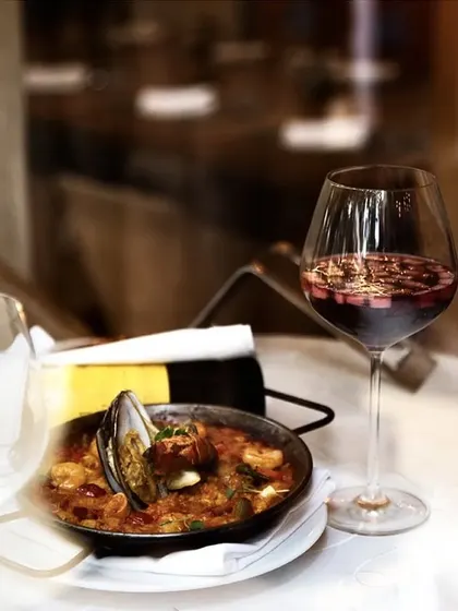 A classic seafood Paella paired with a glass of our homemade red wine Sangria. This is a quintessential Spanish combination that we highly recommend.