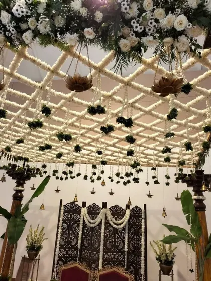 Another perspective of the traditional mandap, showing the intricate details of the floral ceiling and the elegant seating arrangement, all designed to create a perfect setting for sacred rituals.