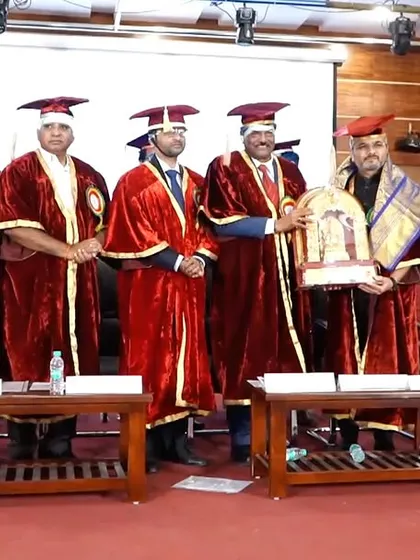 A group photo with the college leadership, holding the memento I was presented with.
