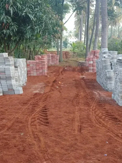 A duplicate image showing the piles of pavers and the dirt path, ready for the transformation of the farm garden entrance.