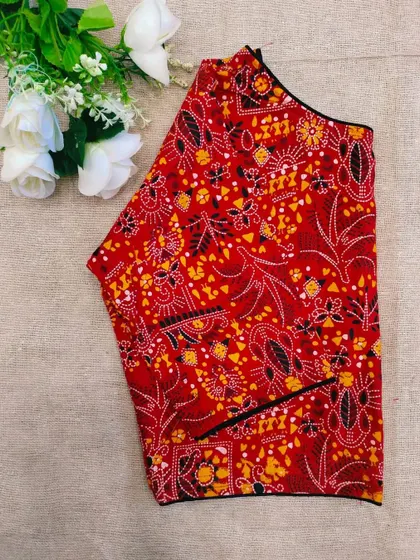 A bright red cotton boatneck blouse with an intricate all-over print.