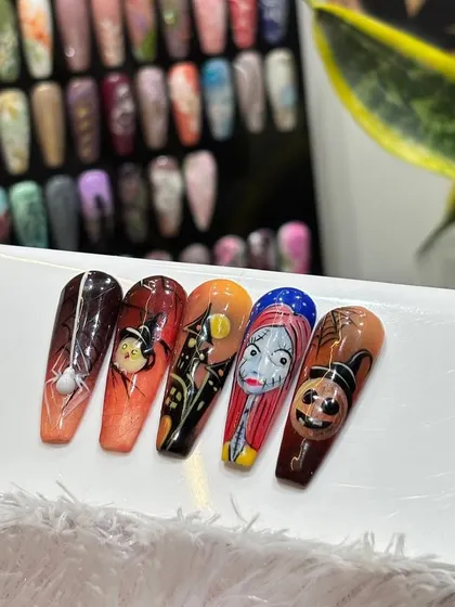 Getting into the spooky spirit with this full set of Halloween-themed nail art. Inspired by "The Nightmare Before Christmas," this collection includes hand-painted characters, pumpkins, spiderwebs, and haunted houses.