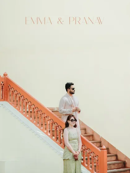 A minimalist and stylish portrait of the couple on a staircase, their cool sunglasses and chic outfits creating a modern, editorial feel.