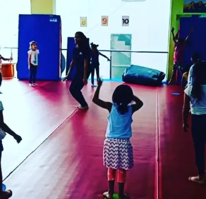 A Friday evening class with our "Good Friends" group. The images show a variety of activities, from warm-up exercises to practicing cartwheels with instructor support.
