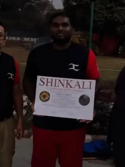 Another student being awarded his SHINKALI certificate.