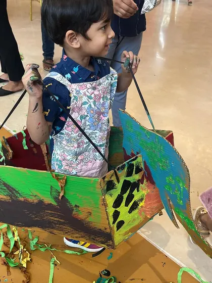 The fun doesn't stop when the painting is done. This young creator turned his painted cardboard box into a wearable elephant costume, showing how art sparks imaginative play.