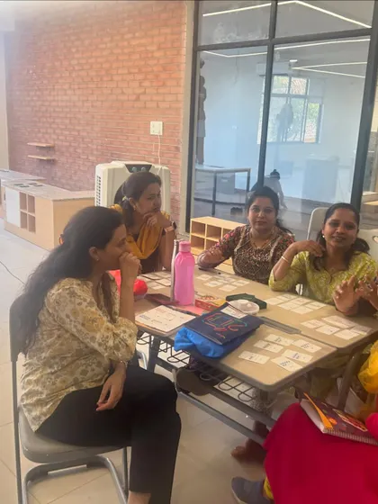A group of teachers at DPS Hinjawadi looking thoughtful and engaged during a discussion. My goal is to spark new ideas and encourage reflection on current teaching practices.