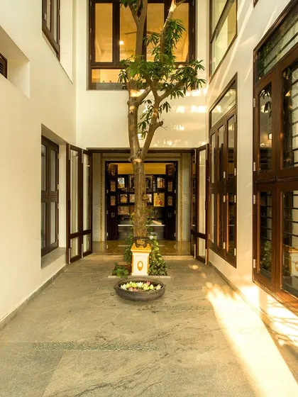 This view shows the full height of the internal courtyard, with surrounding windows from various rooms looking into this green, light-filled space.
