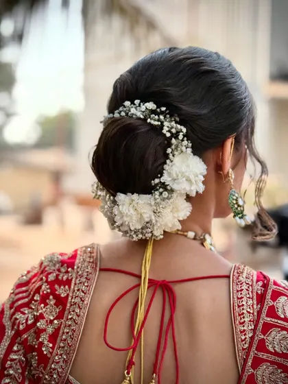 Another view of this elegant bridal bun, showing the placement of baby's breath and carnations.