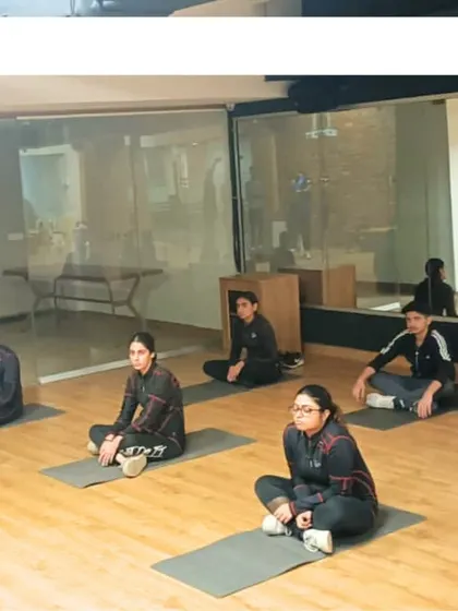 Mental and physical conditioning are key. Here, our shooters participate in a yoga and focus session during a training camp, a core part of our holistic development approach.
