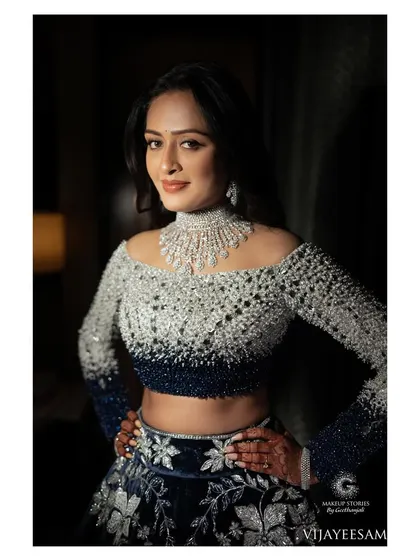 Ashitha looking confident and beautiful. The makeup is a perfect example of modern bridal glam, with a focus on sculpted features and a polished finish.