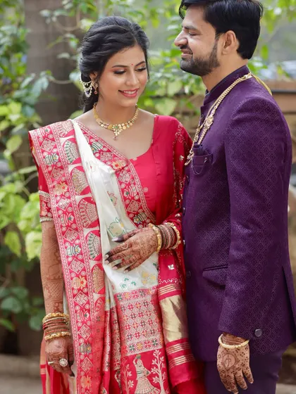 A sweet moment with her partner. Her makeup looks flawless and natural, perfect for a daytime traditional ceremony.