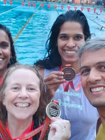 Posing with our medals and coaches after the Masters meet. It's a team effort, and we're grateful for the guidance that gets us to the podium.