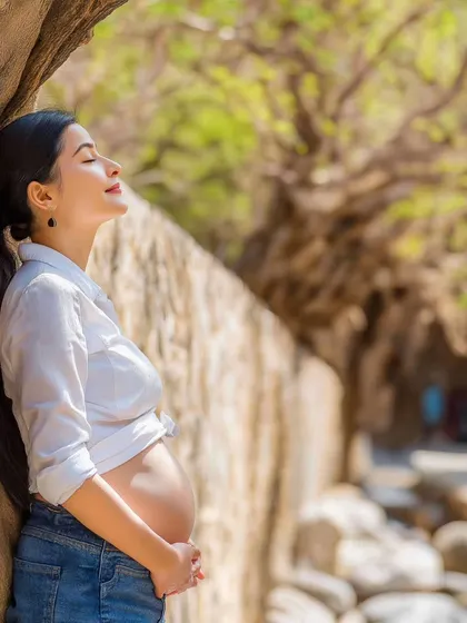 Embracing the beauty of motherhood, one moment at a time. This serene outdoor portrait captures the joy of this special journey, bathed in natural sunlight.