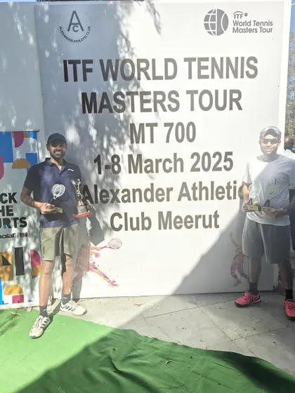 Standing proud with our trophies in front of the ITF World Tennis Masters Tour MT700 banner. Every win is a milestone.