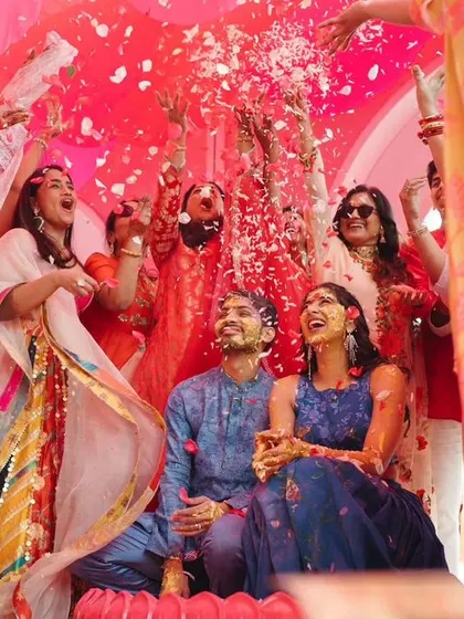 A 'Gulabi Haldi' where the couple is showered with pink petals, a vibrant and joyous twist on the traditional ceremony.