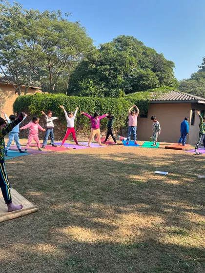 A wide shot of our kids' Christmas yoga event, with children joyfully stretching under the winter sun. It was a beautiful day of community and celebration.