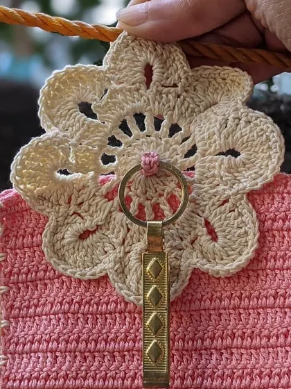 A closer look at the intricate floral lace detail on one of our custom phone pouches. We love adding these special touches to our creations.