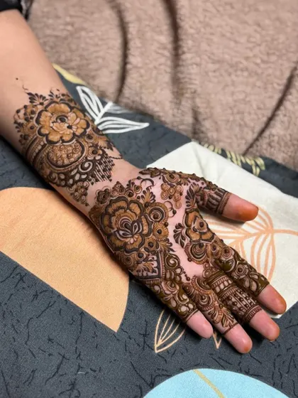 A lovely floral Arabic design on the back of the hand, extending up the arm.