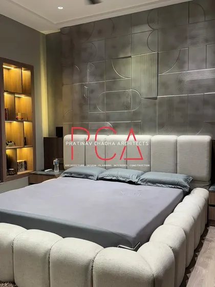 A full view of the son's bedroom, capturing the bed, accent wall, and the illuminated bookshelf niche.