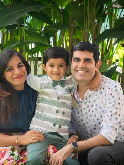 A picture-perfect family of three. This outdoor portrait captures their happy smiles and easy connection, a timeless keepsake of this stage in their lives.