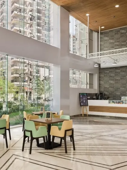 The cafeteria at Sarvodaya Hospital features floor-to-ceiling windows that flood the space with natural light and offer views of the outdoors. This connection to nature enhances the dining experience for patients, staff, and visitors.
