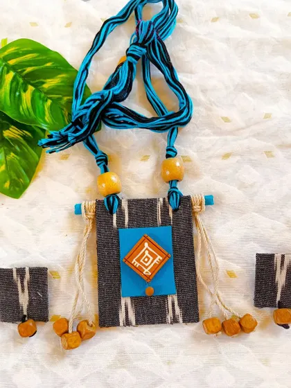 The same Ikat-inspired fabric necklace in a grey and blue color combination.