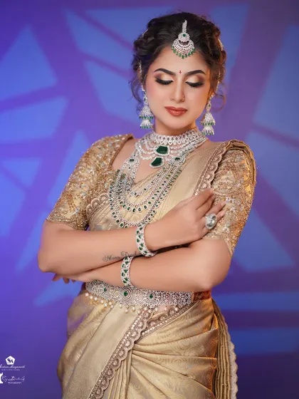 This pose highlights the elegant hairstyle and the way the makeup enhances the bride's side profile.