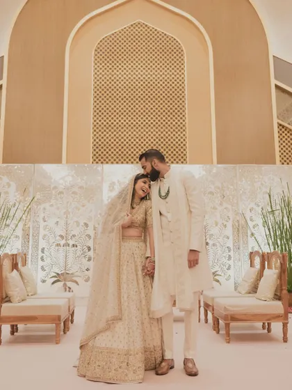 A wide shot of the couple after the ceremony. The decor is as elegant and understated as her bridal look.