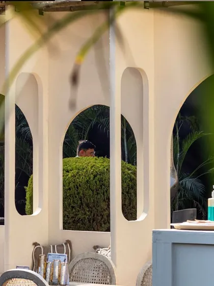 A view through the arched cutouts in the walls of the Cafe Tesu pop-up. This design feature created a sense of openness while framing views of the surrounding greenery.