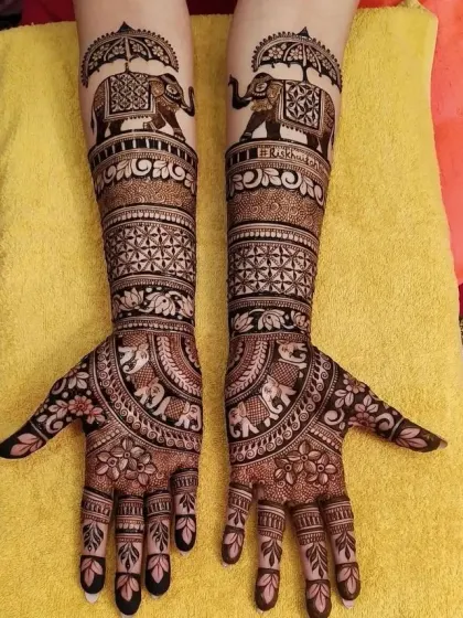 A majestic design featuring elephants under a royal umbrella (chhatri). This is a classic element of Rajasthani and Marwadi bridal mehndi.