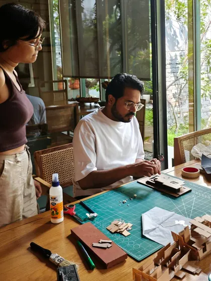 A wider view of a model-making session in our studio. The table is our canvas, where sketches and raw materials are transformed into tangible architectural explorations.
