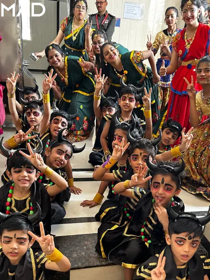 A fun group photo of performers in their devil costumes, full of energy and excitement.