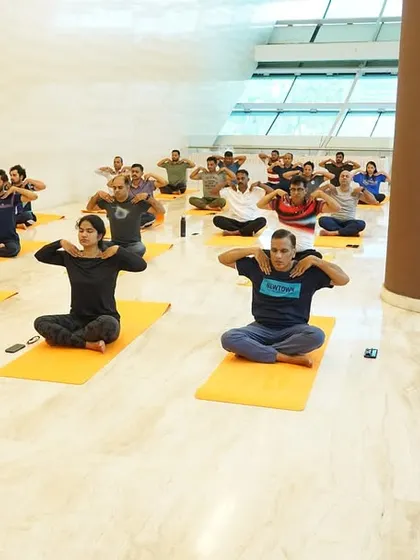 A closer look at employees of ONGC practicing seated stretches. My programs emphasize that wellness is not about complex poses but about consistent, mindful movement.