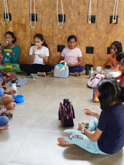 Snack time at the summer camp is also a community affair. Children sit together, sharing their food and building friendships in a mindful environment.
