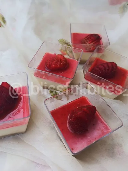 Individual Strawberry Cheesecake shots, a perfect party dessert. These feature a biscuit base, creamy cheesecake layer, and a fresh strawberry topping.