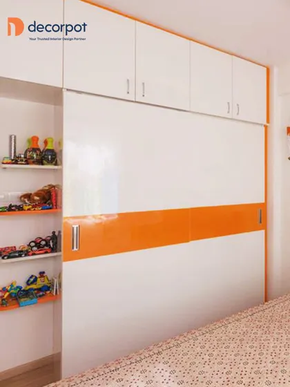 This kid's wardrobe combines a sliding door with open shelving for easy access to toys. The bright orange accent stripe adds a burst of energy to the clean white design.