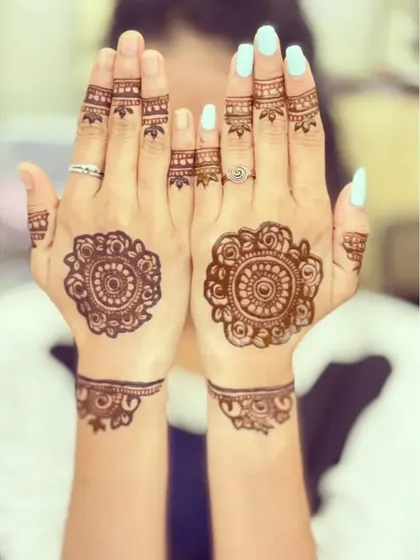 A perfect example of my modern minimalist style. This design pairs a delicate mandala on the back of the hand with a simple wristband and matching finger accents for a chic and elegant feel.