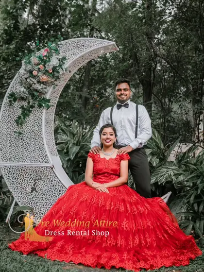 A romantic couple's shot featuring our red lace ball gown and a classic formal look with a white shirt and bow tie. This combination is perfect for creating a whimsical, storybook feel for your pre-wedding album.