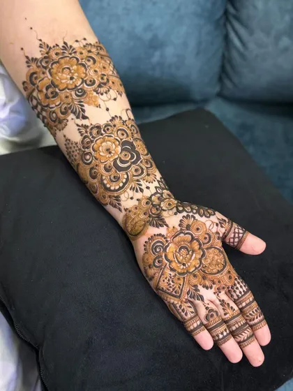 A slightly different angle of the same dense floral henna design.