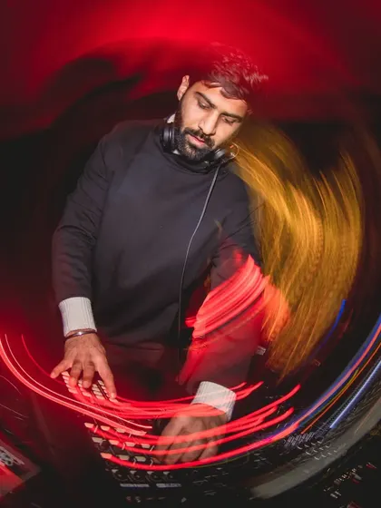 A creative shot with light trails from a New Year's Eve party. This captures the dynamic and fluid nature of a live DJ set.